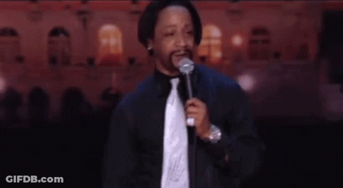 Man In Suit At Microphone On Stage GIF