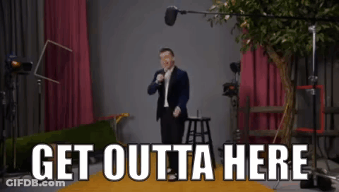 Man In Suit At Microphone Saying Get Outta Here GIF