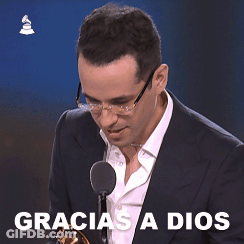 Man In Suit At Microphone Saying Gracias A Dios GIF