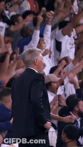 Man In Suit At Microphone Saying King's Back GIF