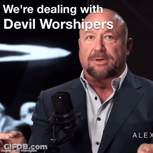 Man In Suit At Microphone Says We're Dealing With Devil Worshippers GIF