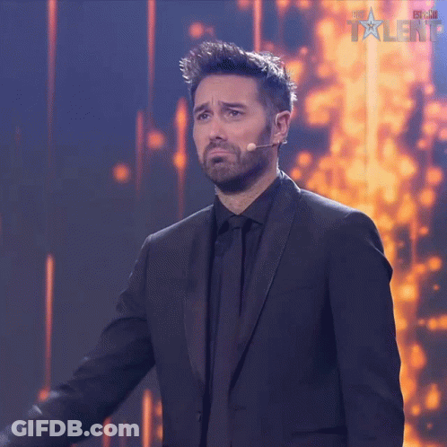 Man In Suit At Microphone With Talent GIF