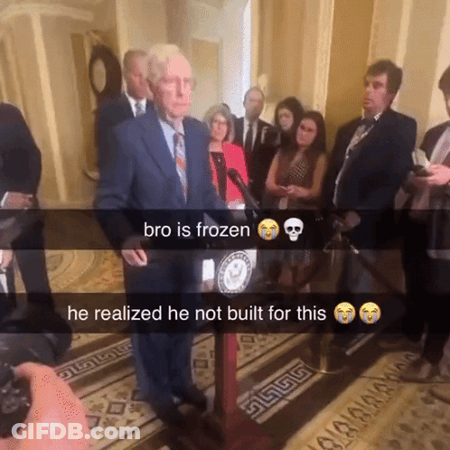 Man In Suit At Podium Bro Is Frozen GIF