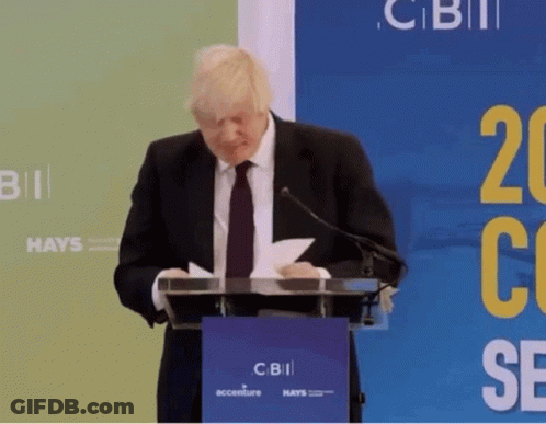 Man In Suit At Podium With CBII Sign GIF