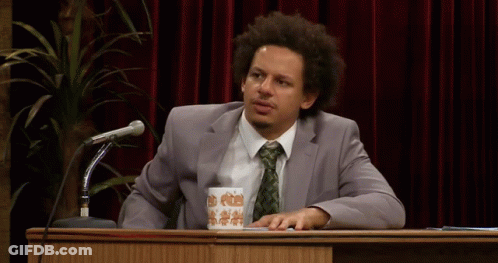 Man In Suit At Podium With Coffee GIF
