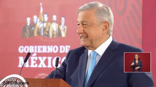 Man In Suit At Podium With Gobierno De Mexico Sign GIF