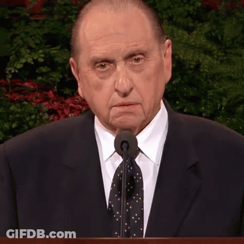 Man In Suit At Podium With Microphone GIF