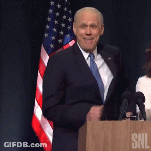 Man In Suit At Podium With SNL GIF