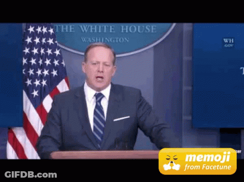 Man In Suit At Podium With White House Flag GIF