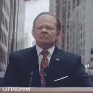 Man In Suit At Podium GIF