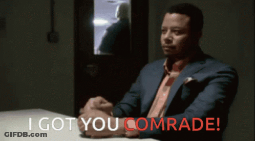Man In Suit At Table With I Got You Comrade In Red GIF