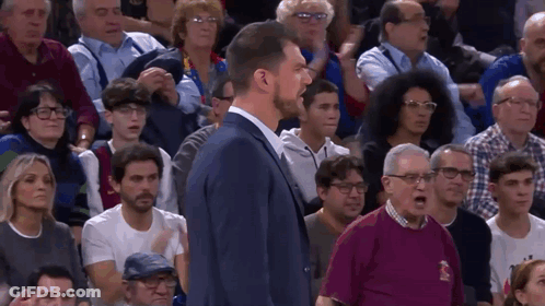 Man In Suit Before Crowd With Polo Shirt Man GIF