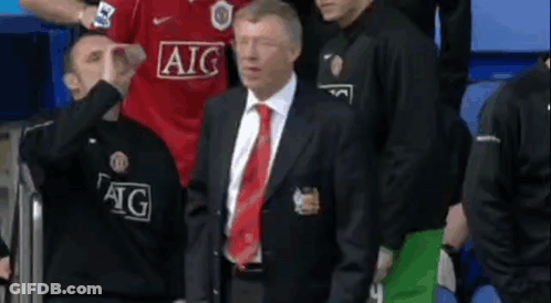 Man In Suit Before Group In AIG Jerseys GIF
