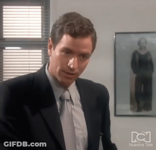 Man In Suit Before Woman Photo Nuestra Tele GIF