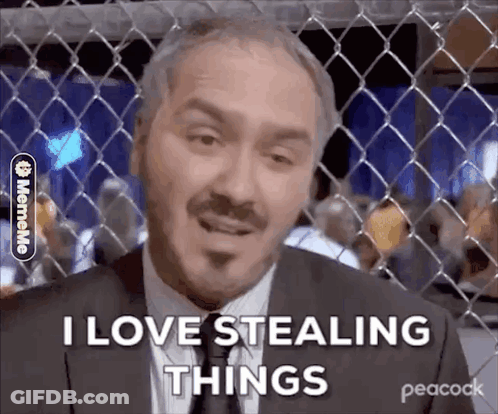 Man In Suit Behind Chain Link Fence GIF
