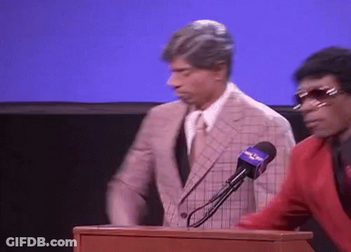 Man In Suit Behind Podium With Fox News Microphone GIF
