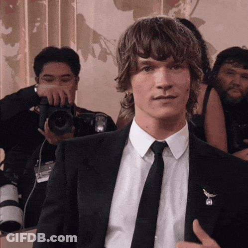 Man In Suit Being Photographed GIF