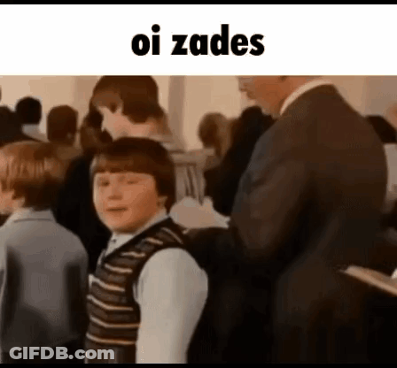 Man In Suit Beside Boy In Striped Vest GIF