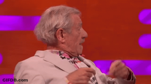Man In Suit Beside Man In Black Suit GIF