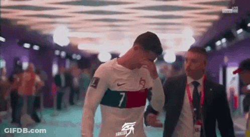 Man In Suit Beside Soccer Player In White Shirt GIF