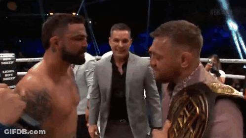 Man In Suit Between Boxers Lions Boy Sign GIF