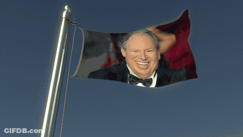 Man In Suit Between Two Hearts Saying Hans Zimmer My Beloved GIF