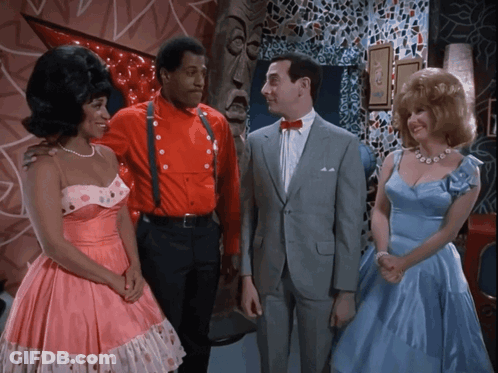Man In Suit Between Women In Pink And Man In Red GIF