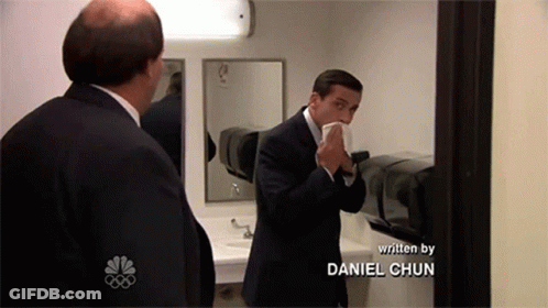 Man In Suit Blowing Nose In Mirror Daniel Chun GIF