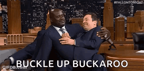Man In Suit Carrying Another Man Buckle Up Buckaroo GIF