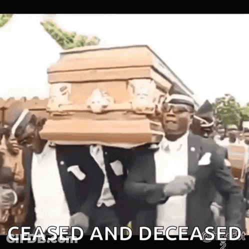 Man In Suit Carrying Coffin In Cemetery GIF