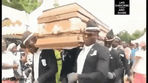 Man In Suit Carrying Coffin On Head GIF
