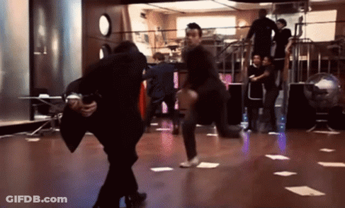 Man In Suit Carrying Man On Dance Floor GIF
