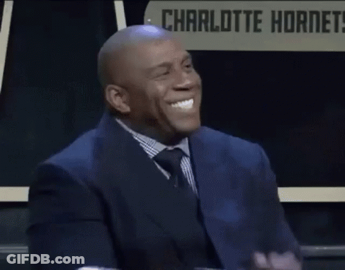 Man In Suit Clapping Before Charlotte Hornets Sign GIF