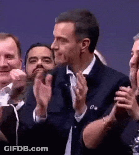 Man In Suit Clapping In Crowd GIF