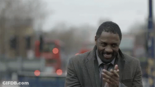 Man In Suit Clapping In Front Of Bus GIF