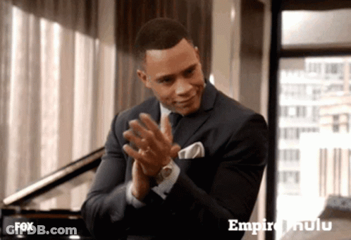 Man In Suit Clapping In Front Of Fox Advertisement GIF