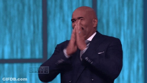 Man In Suit Clapping In Front Of Steve Harvey Logo GIF