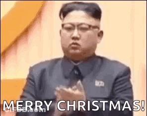Man In Suit Clapping Saying Merry Christmas GIF