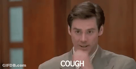 Man In Suit Coughing While Sitting In Chair GIF