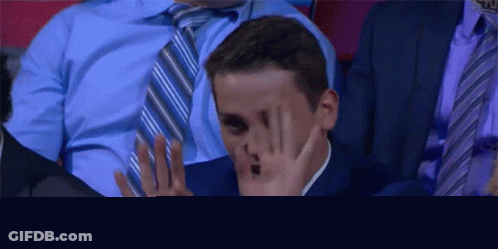 Man In Suit Covering Face GIF
