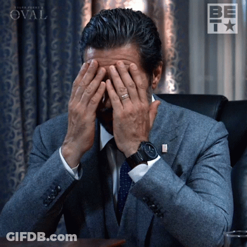 Man In Suit Covering Face GIF