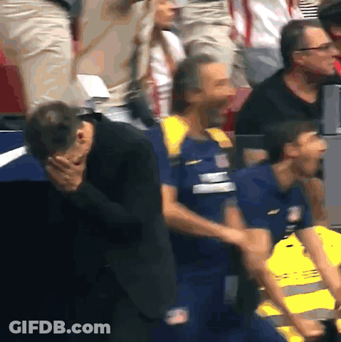Man In Suit Covering Face Beside Safety Vest Man GIF