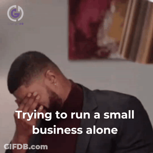 Man In Suit Covering Face Trying To Run Small Business Alone GIF