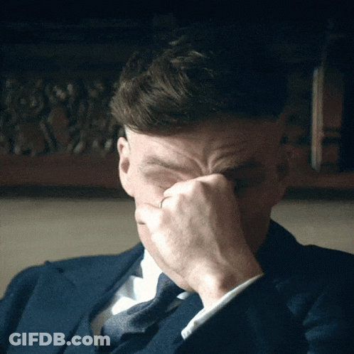 Man In Suit Covering Face With Hand GIF