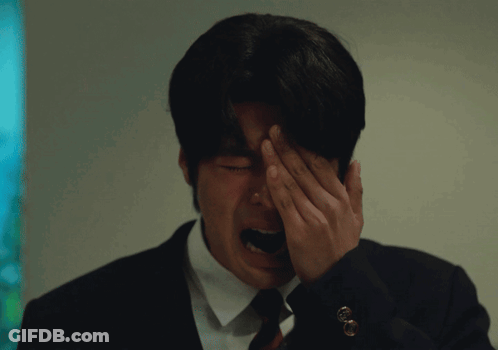 Man In Suit Covering Face With Hand GIF