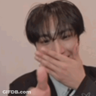 Man In Suit Covering Mouth And Thumbs Up GIF