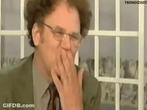 Man In Suit Covering Mouth Laughing GIF