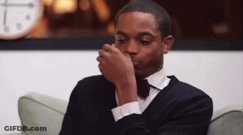 Man In Suit Covering Nose GIF