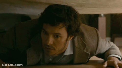 Man In Suit Crawling Under Table GIF