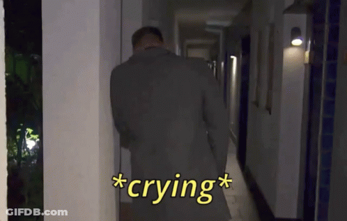 Man In Suit Crying In Hallway At Night GIF